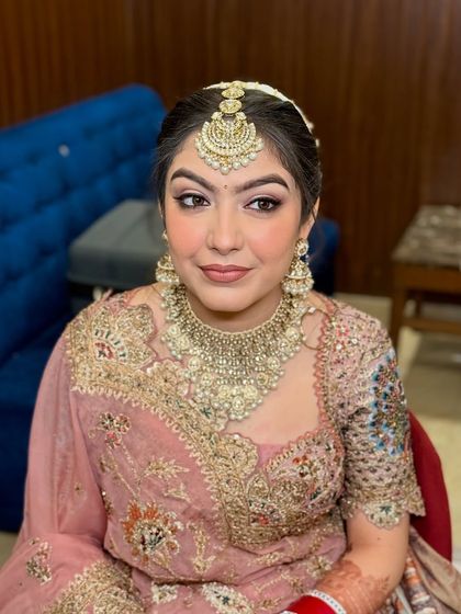 Another angle of Jasleen's look, showing how the makeup looks from the side, complementing her hairstyle and jewelry.