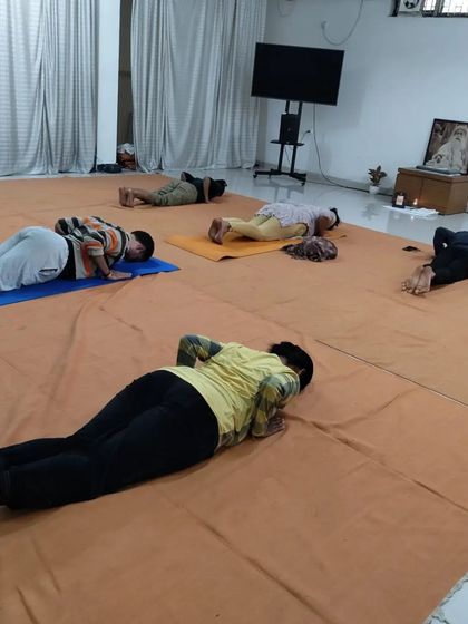 Participants lie in a resting posture during the Surya Kriya class, allowing the body to integrate the energy.