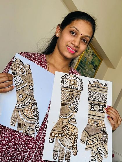 A student proudly displaying her intricate bridal design practice sheets. This is the result of dedication and consistent practice during the course.