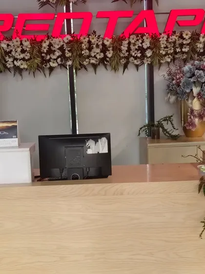 Here, I decorated the main reception area for the RedTape office. I placed fresh floral arrangements directly below the company logo to reinforce the brand identity right at the entrance.