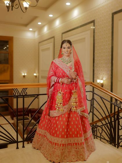 A full-length portrait of my beautiful bride Kannu. Her classic red lehenga is perfectly complemented by a soft glam makeup look, with defined eyes and a radiant complexion.