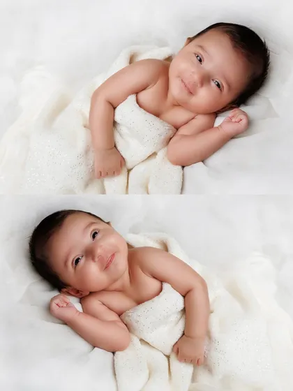 Two beautiful portraits of a smiling newborn wrapped in a soft white blanket, showcasing their bright eyes and happy expression.