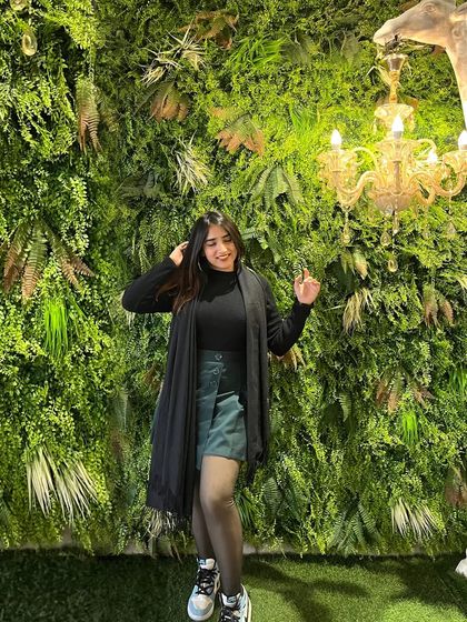 A smiling shot in front of a green wall. This is a simple but effective way to create a vibrant and fresh look.