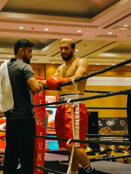 A quick strategy discussion with my corner man during a professional fight. Teamwork is critical both inside and outside the ring.