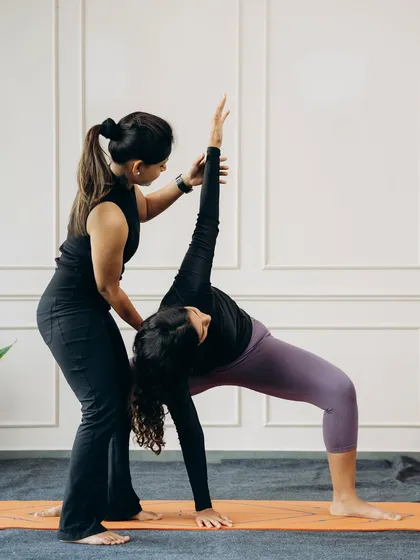 In Camatkarasana (Wild Thing), proper alignment is key to feeling the expansive heart-opening benefits. I am supporting the student's back and guiding their arm to create a beautiful, stable arch.