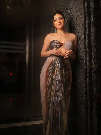 A full-length shot of this editorial-style look. The makeup is clean and radiant, letting the unique outfit take center stage.