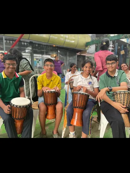 Young participants proudly hold their drums during the inclusive workshop. We believe in the power of collective rhythm to create spaces where everyone feels valued and supported.