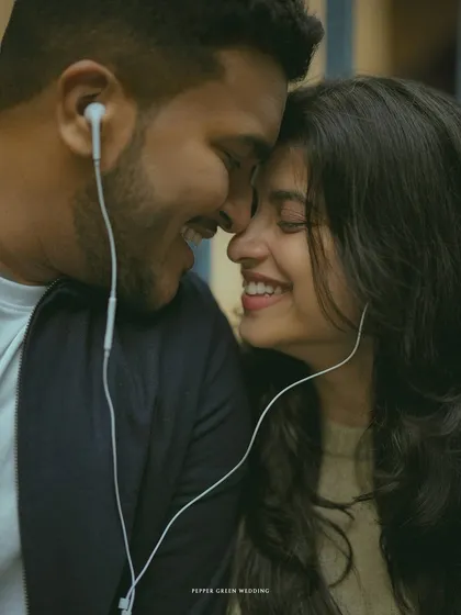 Sharing a private world with a shared pair of earphones. This intimate pre-wedding portrait is a modern take on romance, focusing on a simple, shared experience.