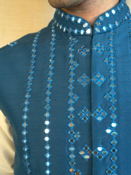 A detailed view of the geometric and floral mirror work, showcasing a classic craft reimagined for the modern man.