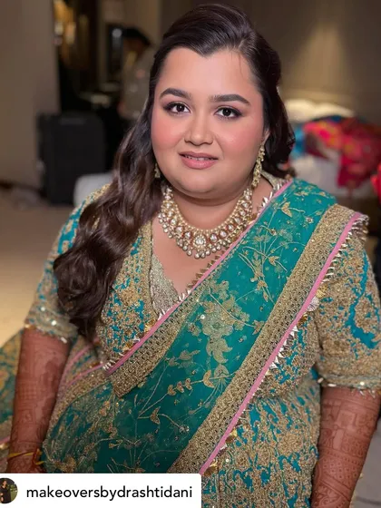 A front-facing portrait of her Sangeet makeup. The focus is on her beautifully defined eyes and flawless skin, creating a look of pure elegance.