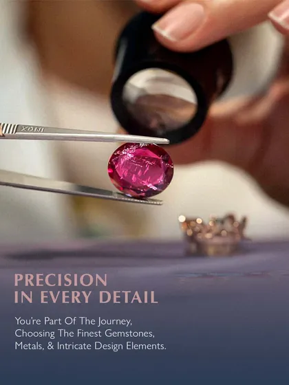 Precision in every detail. You are part of the journey, from choosing the finest gemstones to approving the intricate design elements. Here, a ruby is being inspected with a loupe to ensure its quality is up to my exacting standards.