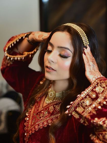 A classic pose that highlights the elegant headband and the rich embroidery of the Kashmiri velvet dress. This is a perfect shot for showcasing bridal or special occasion styling.