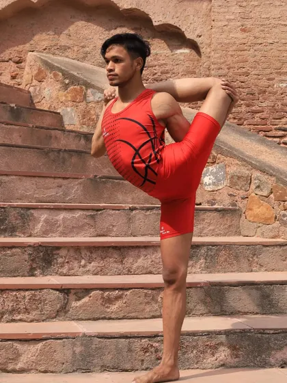 Yoga is a path of continuous growth. Here, a student demonstrates a standing backbend variation, a testament to the strength and discipline we cultivate in our advanced classes.