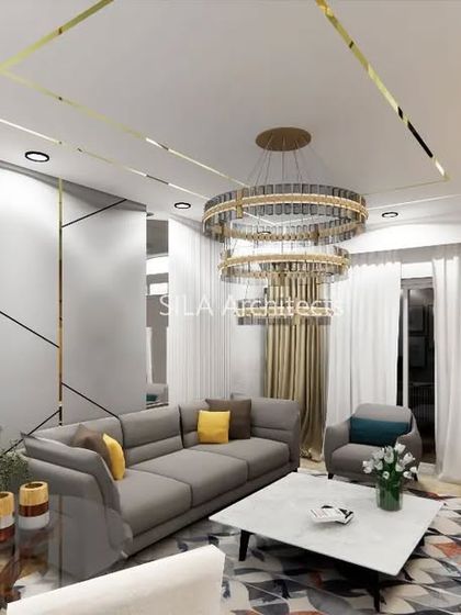 Another view of the Bannerghatta living room concept, highlighting the elegant grey sofa and geometric wall paneling with gold inlay.