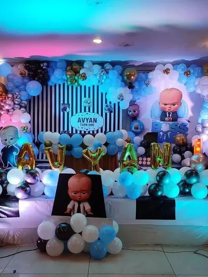 I can also do popular character themes, like this "Boss Baby" first birthday party. The stage decoration includes multiple balloon arches, character cutouts, and custom name foils to match the theme perfectly.