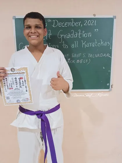 All the happiness is for the new belt. This student is thrilled to receive his purple belt after passing the karate exam. 💜