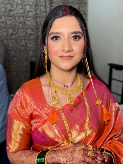 Another shot of the Maharashtrian bride, showcasing her beautiful smile and the traditional gold jewelry.