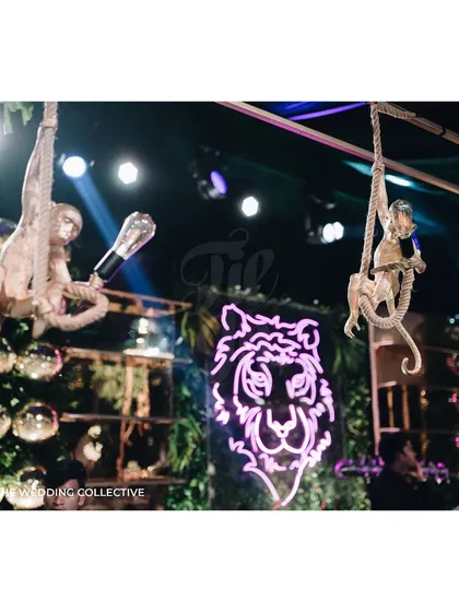 Details make the design. For our 'Savannah Splendour' Sangeet, the bar was a key feature, with playful monkeys hanging from a custom metal structure and a bold neon tiger sign creating a memorable and high-energy focal point.
