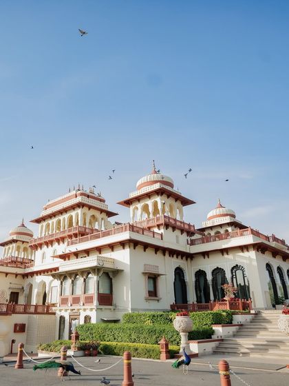 The majestic Rambagh Palace in Jaipur, with its resident peacocks, stands as a silent witness to a love story. I often begin by capturing the soul of the venue, setting the stage for the royal wedding that is about to unfold within its walls.