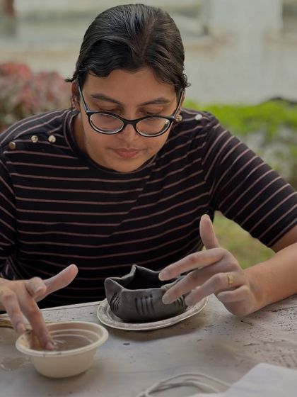 Each piece tells a story of patience and play. This participant is adding the finishing touches to her uniquely shaped bowl during our corporate wellness session.