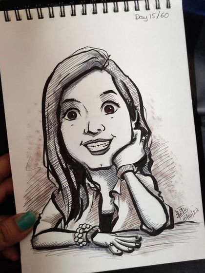 Another look at the smiling caricature, held in hand to show the scale of the sketchbook page.