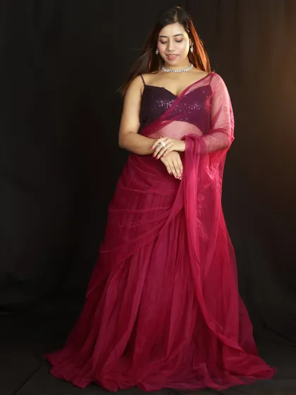 A full-length shot with the model looking down, creating a soft and elegant mood. The simple background keeps all the attention on the outfit.