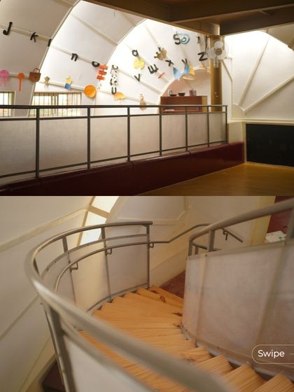The curved ramp and staircase inside the kindergarten block provide a fun and dynamic way to move between levels, adding to the playful character of the space.