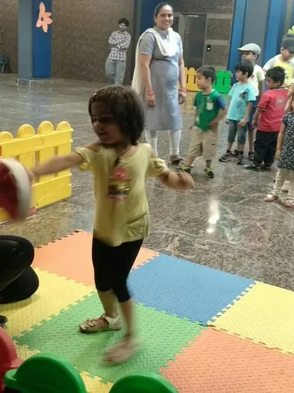 A young student practices her punches with enthusiasm. We focus on positive reinforcement to keep kids engaged and eager to learn.