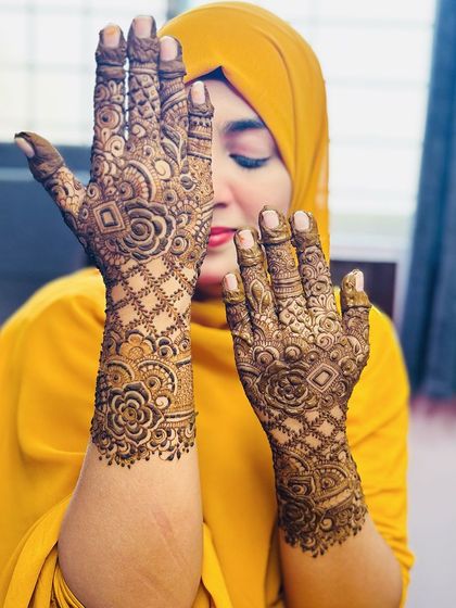 A playful pose showing off the beautiful floral mehendi. The design is perfect for a bride who wants something elegant and not overly dense.