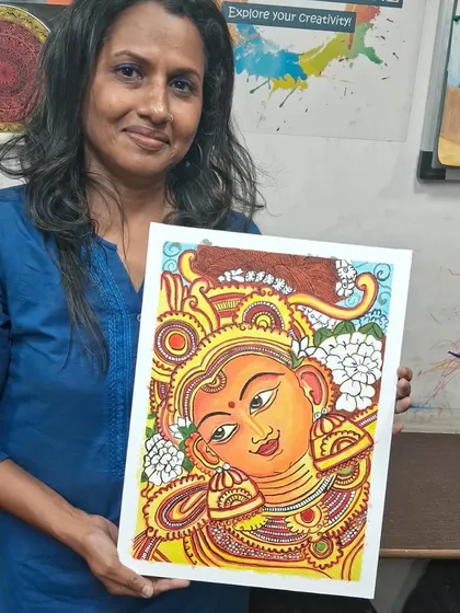 Here is one of our dedicated students proudly displaying her finished Kerala mural. It's so rewarding to watch our adult students master this traditional art form with such focus and passion.