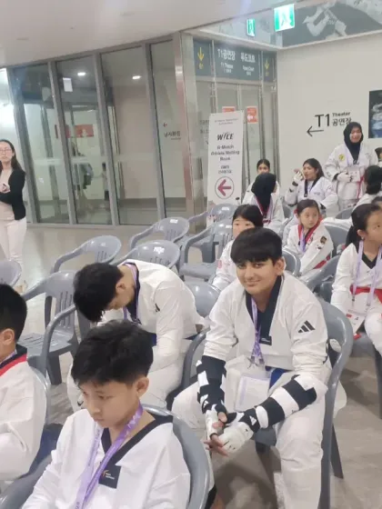 My students waiting patiently for their event to begin, surrounded by competitors from other nations.