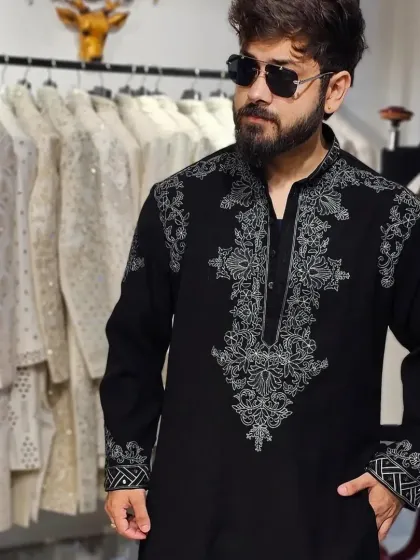 A clearer view of the embroidery pattern on the black kurta.