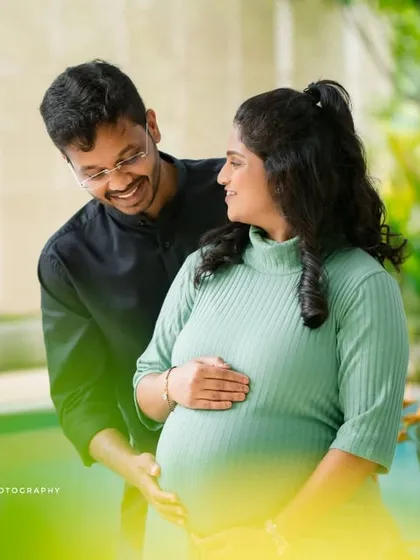 Capturing the pure joy and excitement of expecting. This candid poolside maternity photo highlights the couple's happy smiles and the beautiful baby bump.