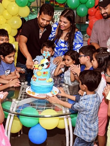 Prishiv and his friends gather around to cut the fun, two-tier pool party cake.