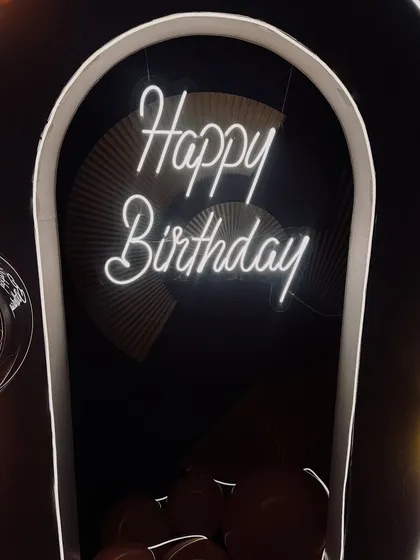 Here's a closer look at the custom neon sign and illuminated arch we used for a birthday at Foo restaurant. The warm glow creates an inviting and celebratory focal point.