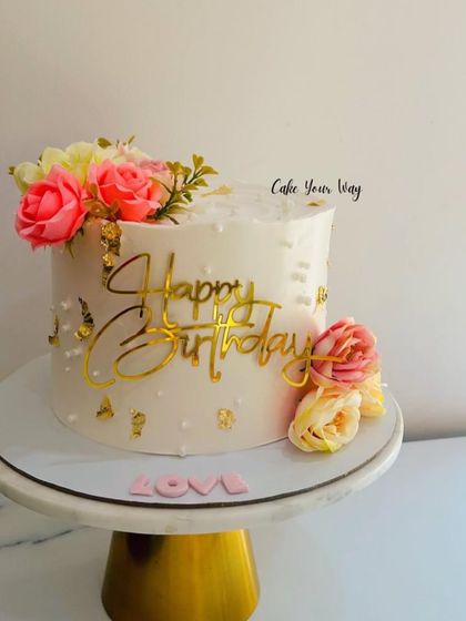 Gold, florals, and a dash of love. A simple yet stunning birthday cake.