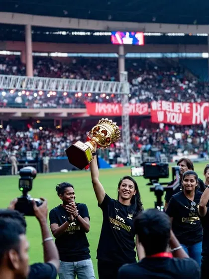 The victorious RCB women's team celebrates with their trophy at the Unbox event. We managed the logistics of this celebratory lap of honor, ensuring a memorable moment for both the players and the thousands of fans in attendance.