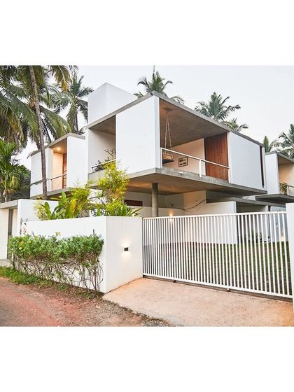 The Aayi House, which translates to 'Mother's House', is designed as a modern interpretation of a traditional courtyard home. The structure is lifted on stilts, allowing the landscape to flow underneath and creating a series of shaded, open-air spaces on the ground floor.