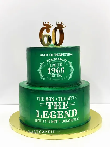 A two-tier cake for a 65th birthday with a "Man, Myth, Legend" theme. This is a zero-fondant design, using stenciling on a deep green buttercream finish.