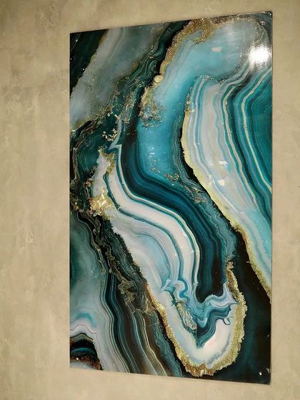 A serene, abstract resin artwork installed at the Ksema spa in Mulberry Shades Resort. The cooling emerald and gold tones were specifically chosen to enhance the spa's tranquil and rejuvenating atmosphere.