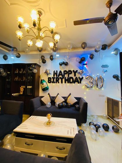 A wider view of the 30th birthday decoration, showing how the balloons on the ceiling and floor complete the party atmosphere in the drawing hall.