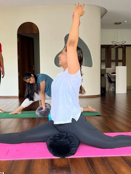 I believe props are helpers, not shortcuts. Here, a student uses a bolster to safely explore Hanumanasana (the splits), finding depth without strain. This is how we make every pose accessible to every body.