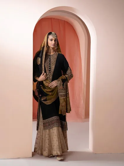 A regal black and beige sharara set, paired with a heavily embroidered dupatta. This look is perfect for grand festive celebrations or weddings.
