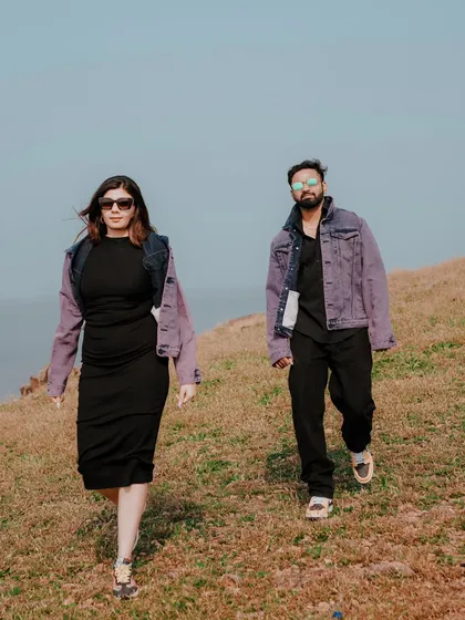 Capturing a cool, confident walk along a coastal hill. This shot has a candid, editorial feel, perfect for couples who want a stylish and modern pre-wedding album.