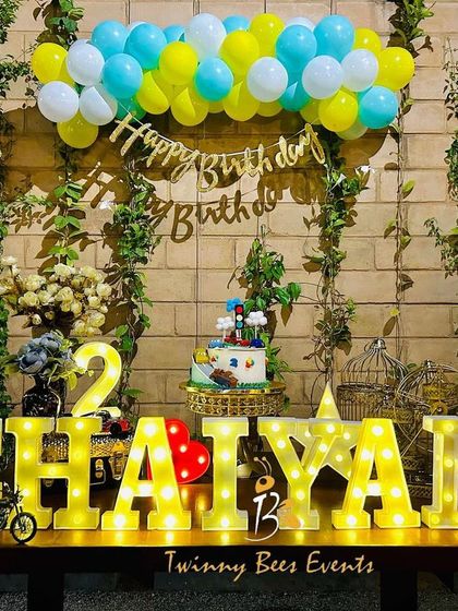 A simple yet striking table decoration for Chaiyan's 2nd birthday. We used large marquee letters of his name as the centerpiece, complemented by a rustic brick wall, climbing vines, and a classic balloon bunch.