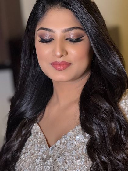 An eyes-closed shot to showcase the soft, shimmery eyeshadow and the flawless finish of her makeup.