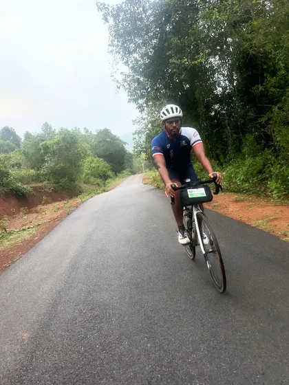 A rider pushes through a scenic, rolling country road during the Jog Falls 1000K BRM. The varied terrain keeps the ride challenging and engaging.
