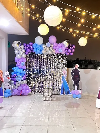 The 'Frozen' party backdrop with character cutouts, perfect for a child's birthday celebration.
