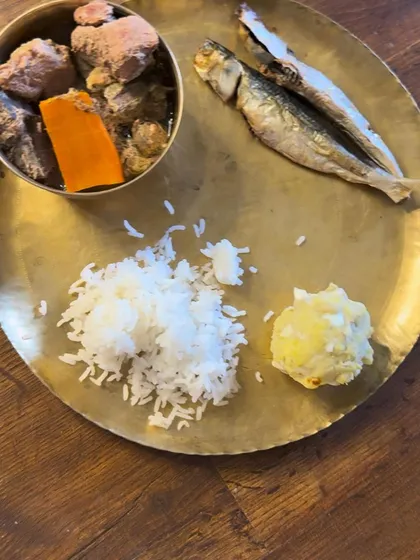 A close-up of Posto's special Bengali thali for the new year, featuring fish, mutton, rice, and mashed potatoes.