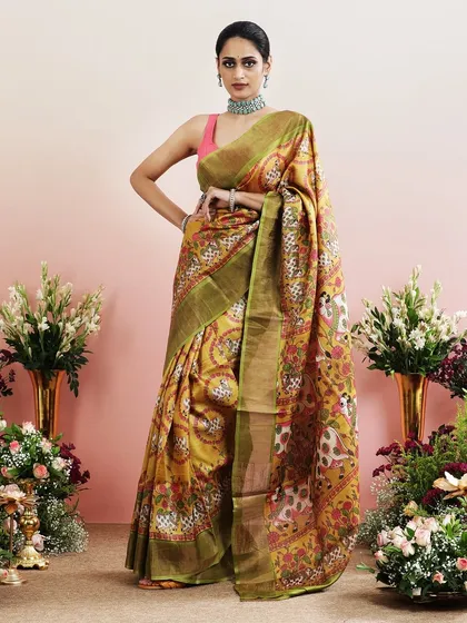 A stunning Pichwai-inspired saree in mustard yellow, with prints of cows and lotus flowers.